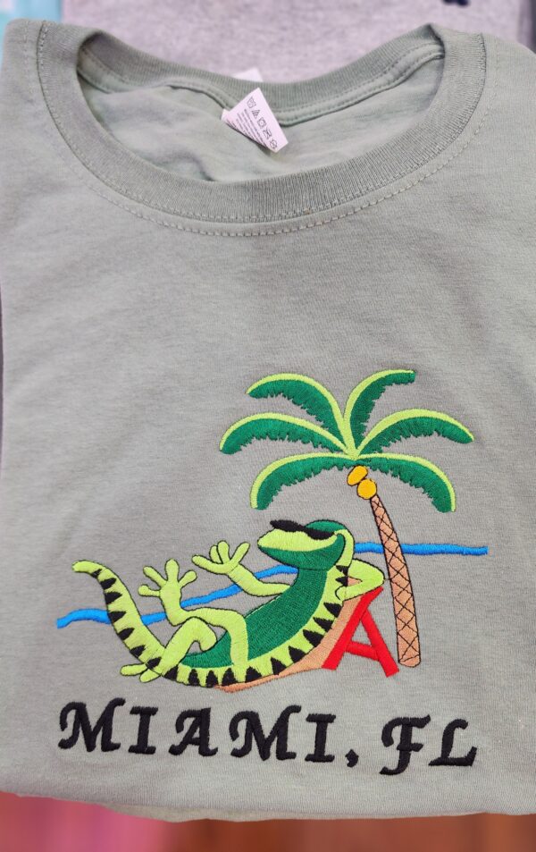 100% Cotton Embroidered Unisex T-Shirt – Miami, Florida / Iguana Relaxing On The Beach In Miami, FL